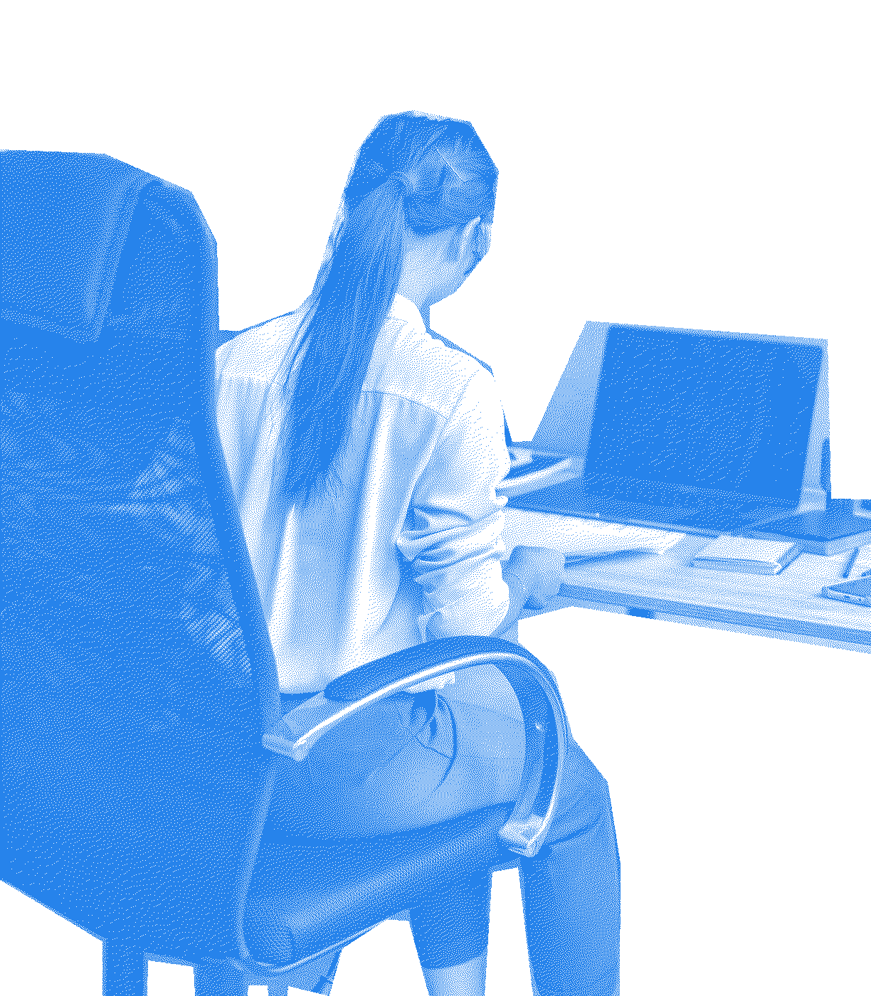 A person seen from behind, sitting in an office chair at a desk with a laptop