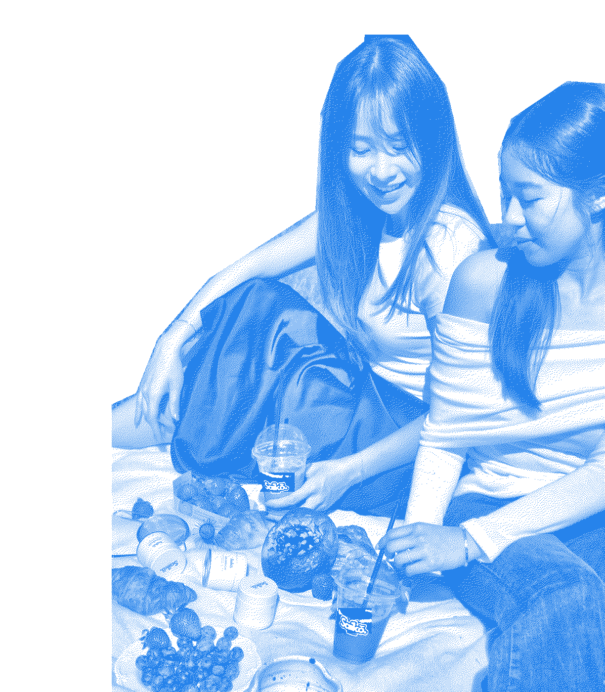 Two friends sharing matcha drinks and pastries at a picnic