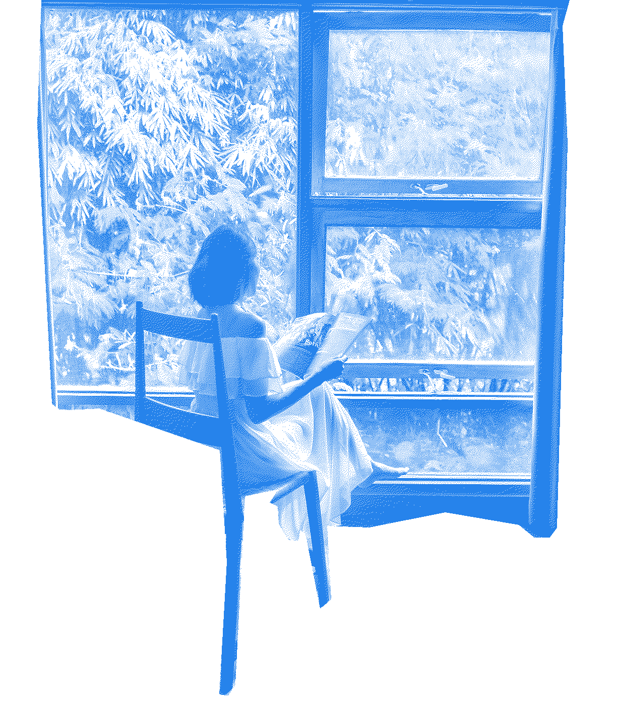 A person sitting in a wooden chair by a large window onto a garden, reading